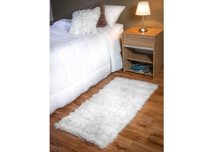 Long white Sheepskin bedside carpet.