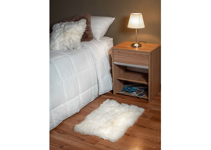 White Sheepskin bedside carpet.