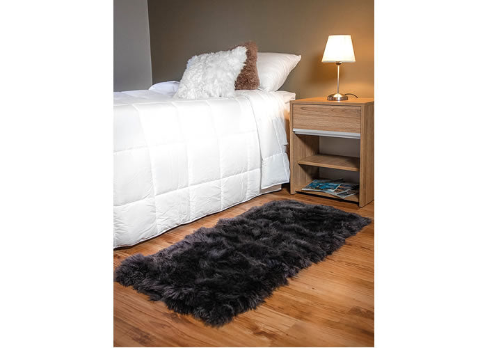 Long grey Sheepskin bedside carpet.