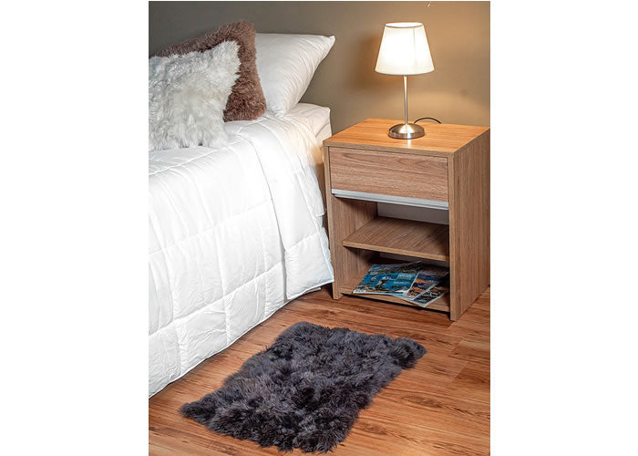 Grey sheepskin bedside carpet.
