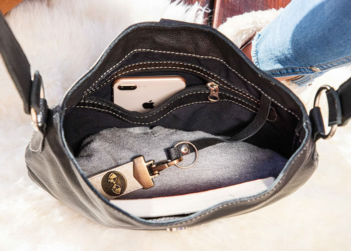 Black leather handbag with fringes.