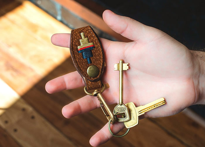 Embroidered capybara leather key ring.