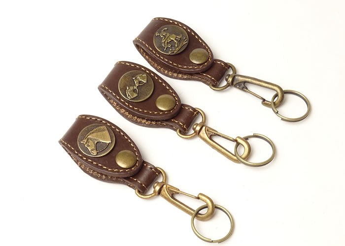 Brown leather key ring with horse applique.