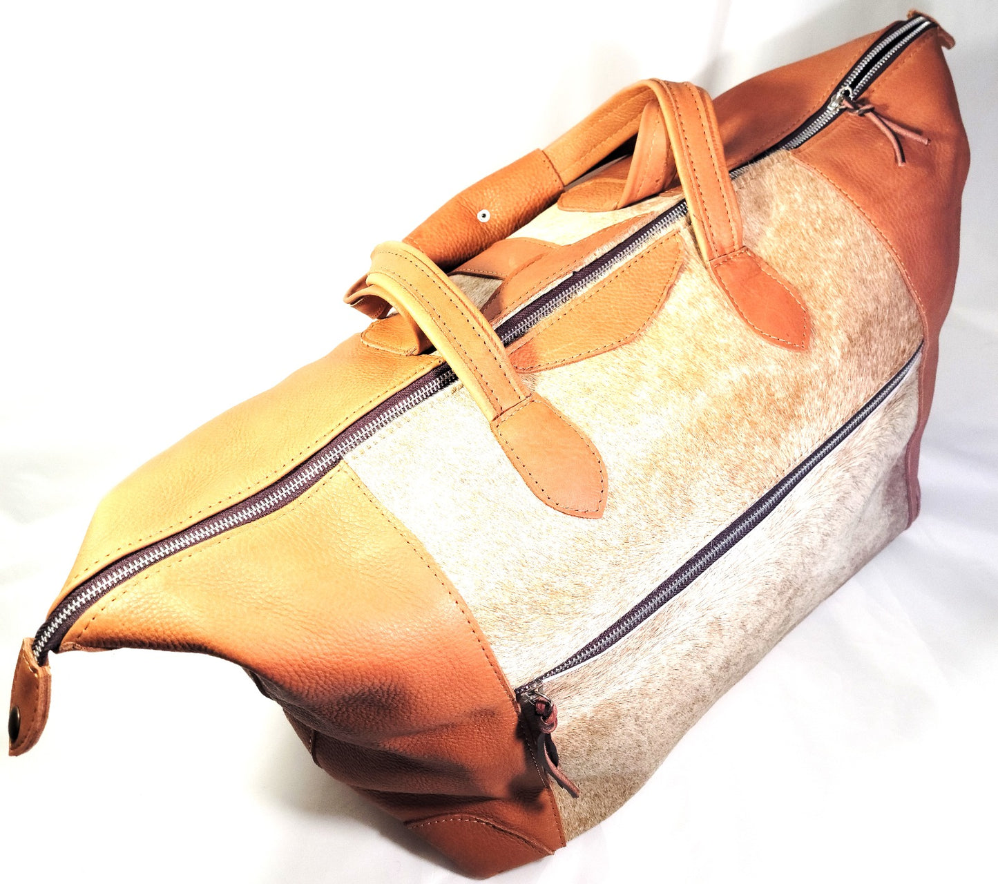 Large cowhide travel bag.