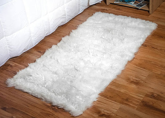 Long white Sheepskin bedside carpet.