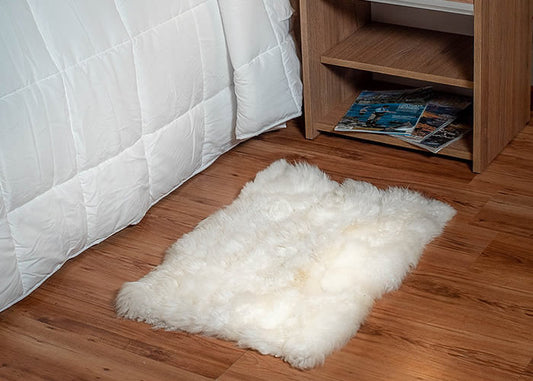 White Sheepskin bedside carpet.