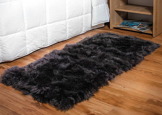 Long grey Sheepskin bedside carpet.