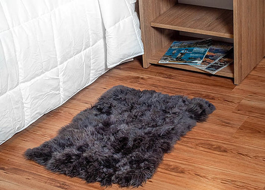 Grey sheepskin bedside carpet.