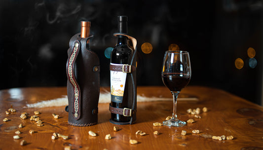 Leather wine holder with buckles.